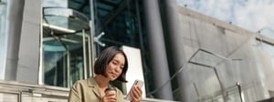 beautiful-smiling-asian-girl-drinking-coffee-using-mobile-phone-sits-stairs-outside-young-1